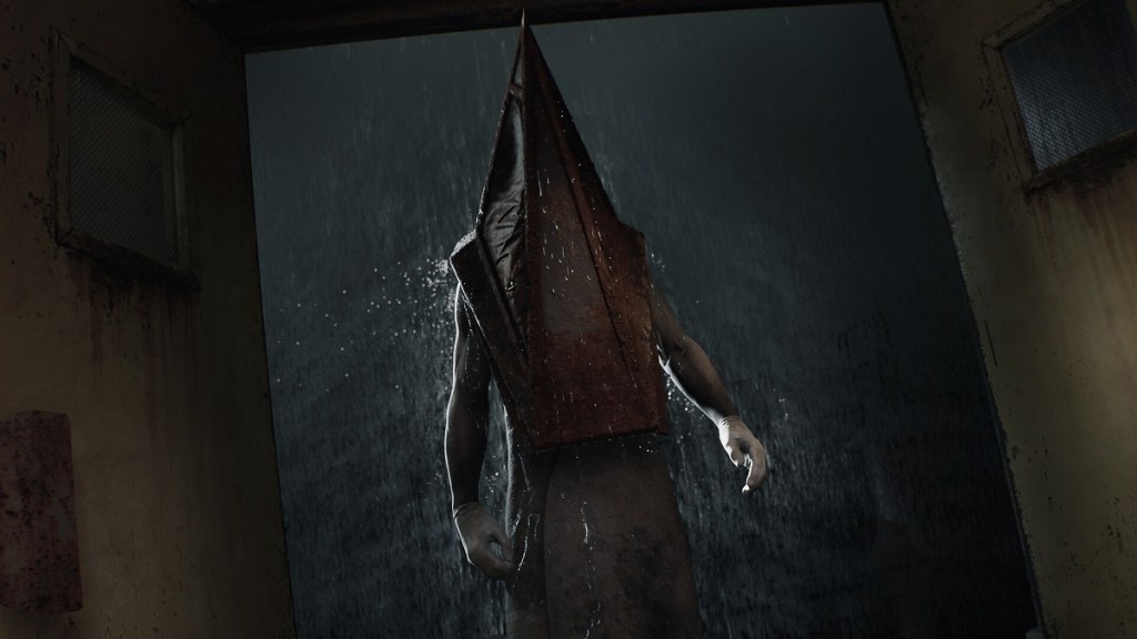 Silent Hill 2 Remake: Pyramid Head stood at an open door with rain pouring down outside.