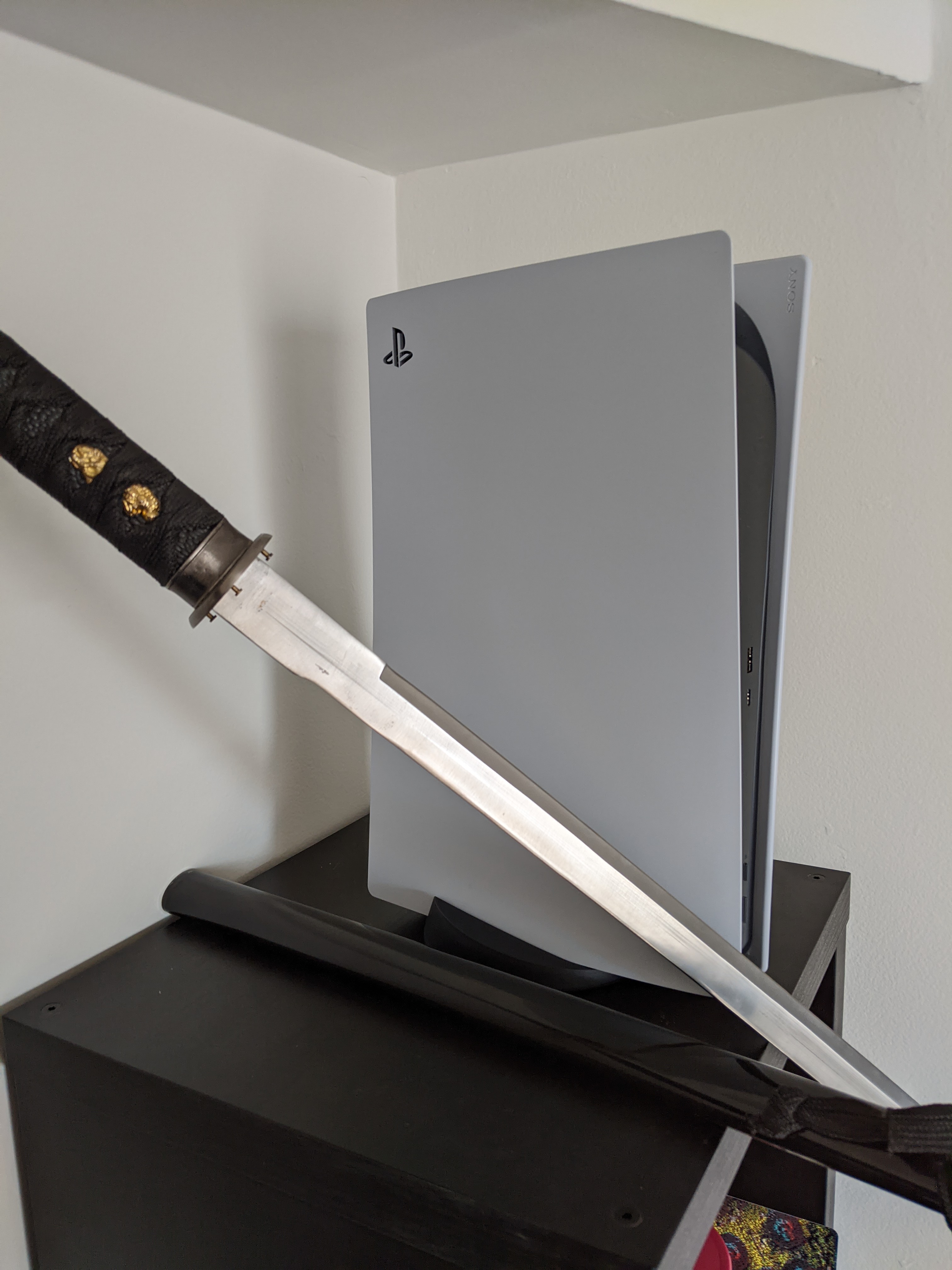 PS5 next to a Katana