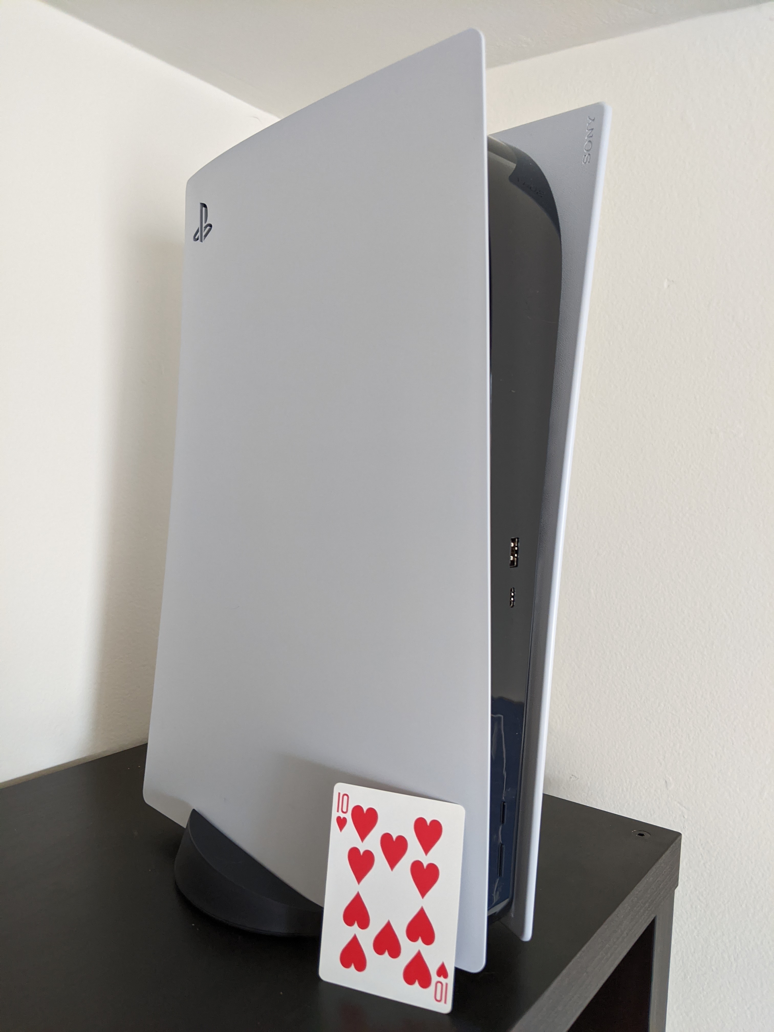 PS5 Next to a Playing Card